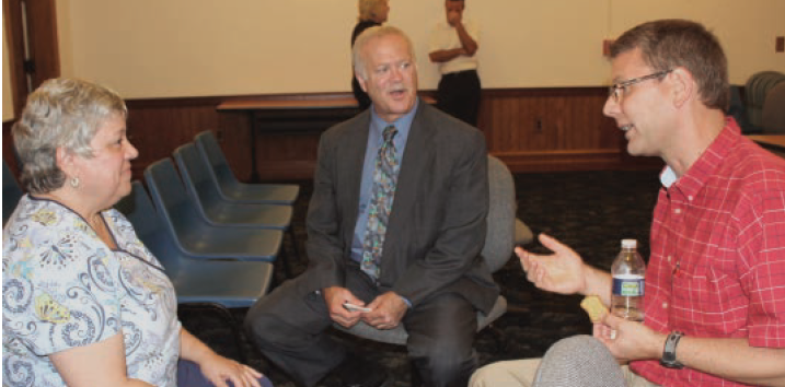 Patricia Brown queries Superintendent Glaes and Dr. David Schriemer, school board member about the "focus" school designation at Sunset Elementary.