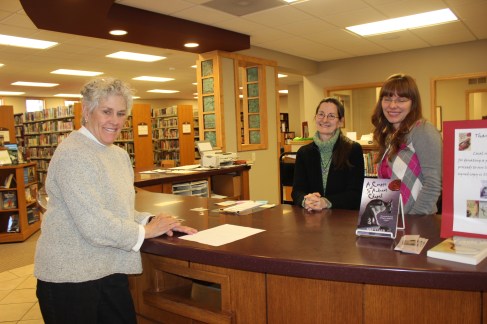 Schoolcraft librarians greet people at the front desk from left to right: Susan Harper-Grieger, Roxanne Wilkins and Faye VanRavensway.