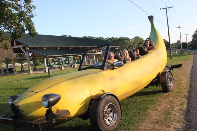 The Banana Car will make an appearance at the Vicksburg Farmers’ Market on August 21 to give free rides, sponsored by SC Enterprises. The passengers seen here are Tom Brown, Alyssa Kirby, with Taigen and Brady Copeland toward the back.