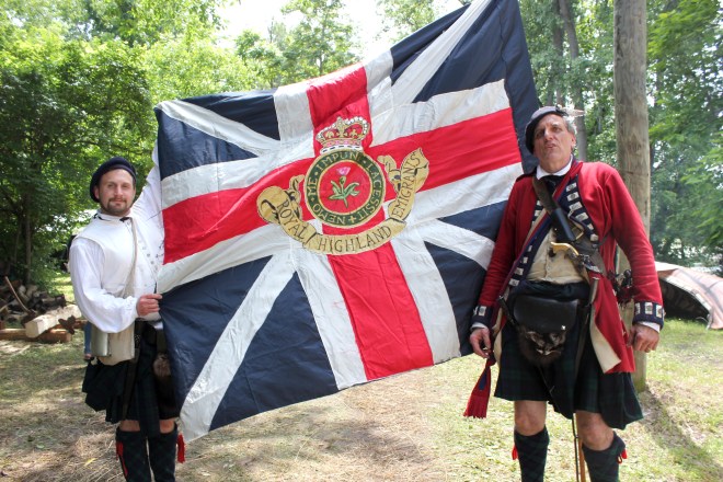 Stefan Sekula and his co-commander Timothy Gora display the flag of the 84th Scottish Highlanders, the unit for which they are re-enactors. This unit served at Fort Michilimackinac.