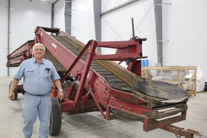 Terry Mleczewski stands beside the conveyor belt that will transport the thousands of pounds of potatoes that will come into the MLC plant every day to be processed.