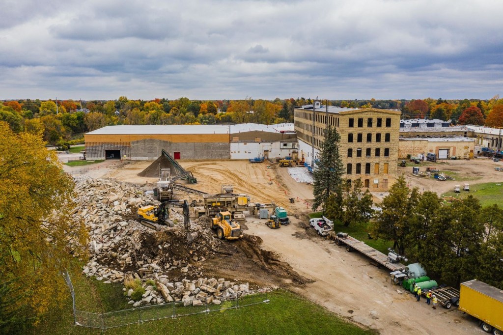 The pile of rubble in the foreground encounters several crushing machines to become the pile of aggregate in the background. Photo by Taylor Kallio, Alterra Media.