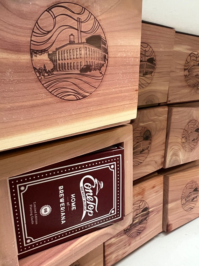 Wooden boxes show a burned in image of the old paper mill.