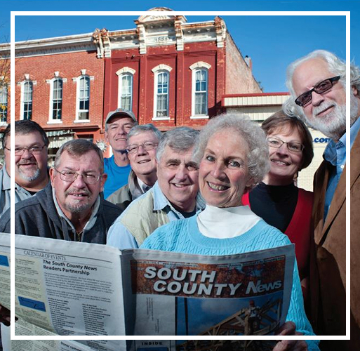 Sue Moore and early SCN staff members with the first issue in print