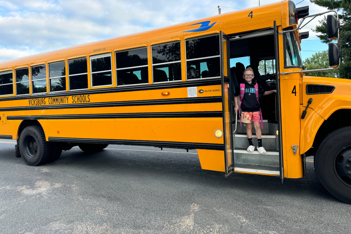 SCN_Article_Feat_Finn_0925 A young student prepares to step off the bus on the first day of the school year.