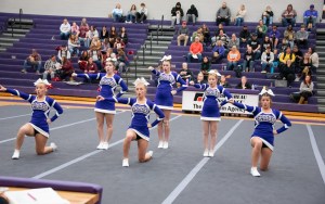 Several purple-clad cheerleaders perform.