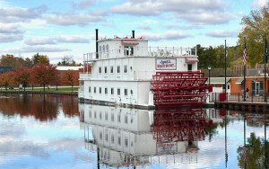 An antique paddleboat on the water.