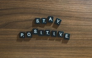 The words "Stay Positive" spelled out with tiles from the board game Scrabble.