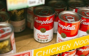 Several red soup cans in a box.