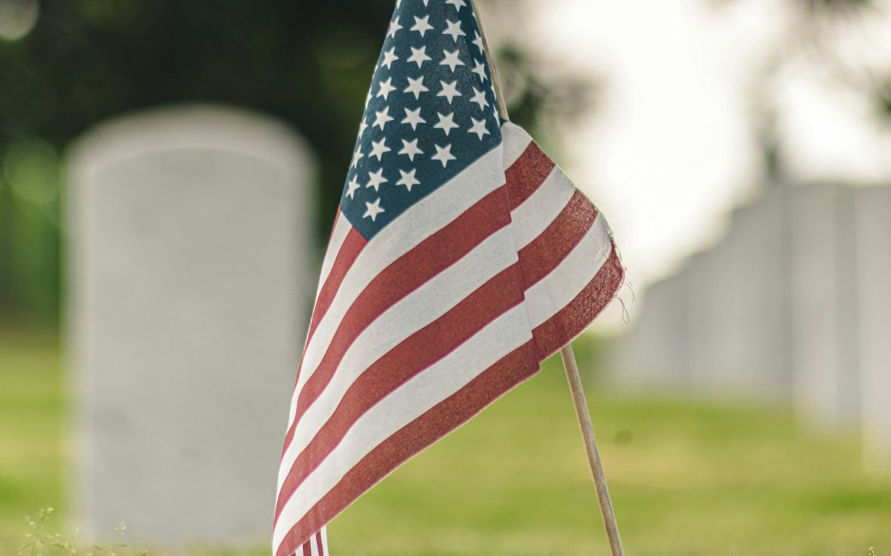 An American flag posted in a cemetery.
