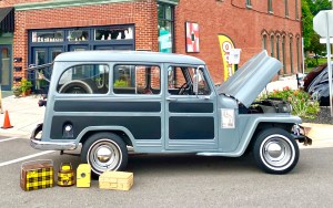 An old car with vintage picnic gear.