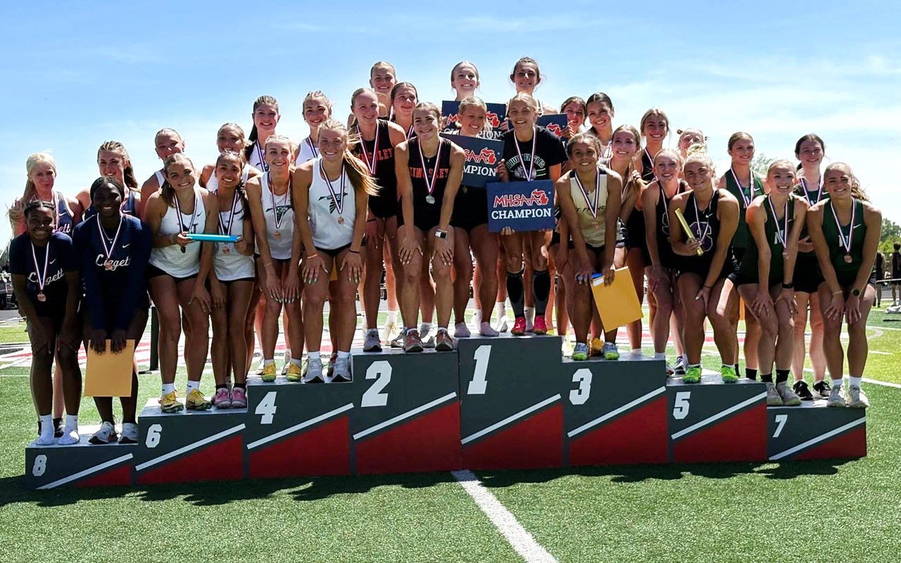 eaglestrack_statefinals Several track team members stand on the winners podium with medals around their necks.