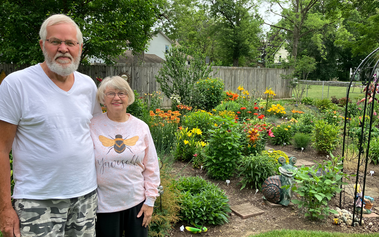 jonesgarden A couple standing in front of a colorful garden.