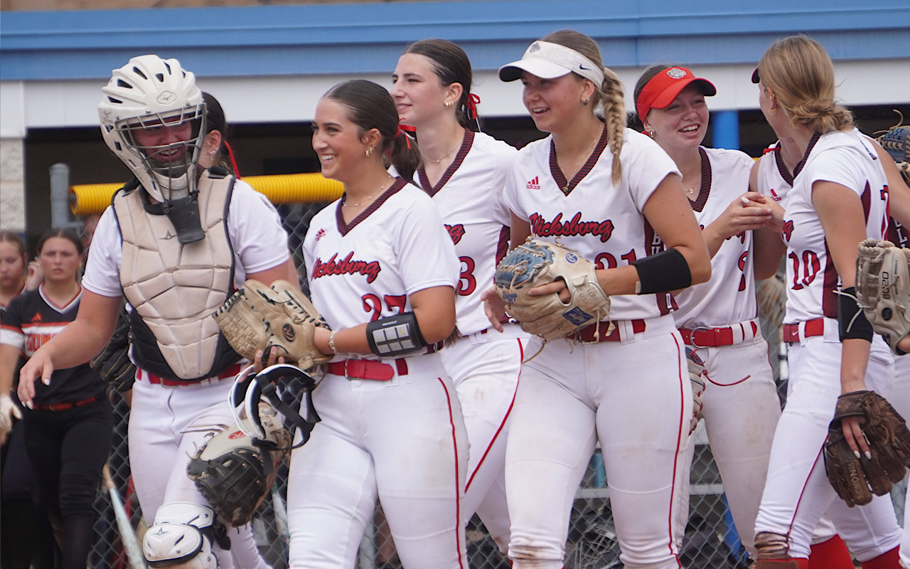 vicksburgsoftballfinalsloss White-uniformed softball plays get ready to hit the field.