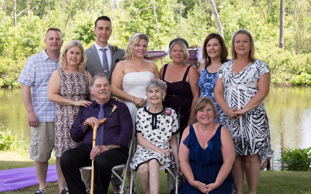 seniormoment_michnicks A portrait of a multi-generational family posing by a lake.