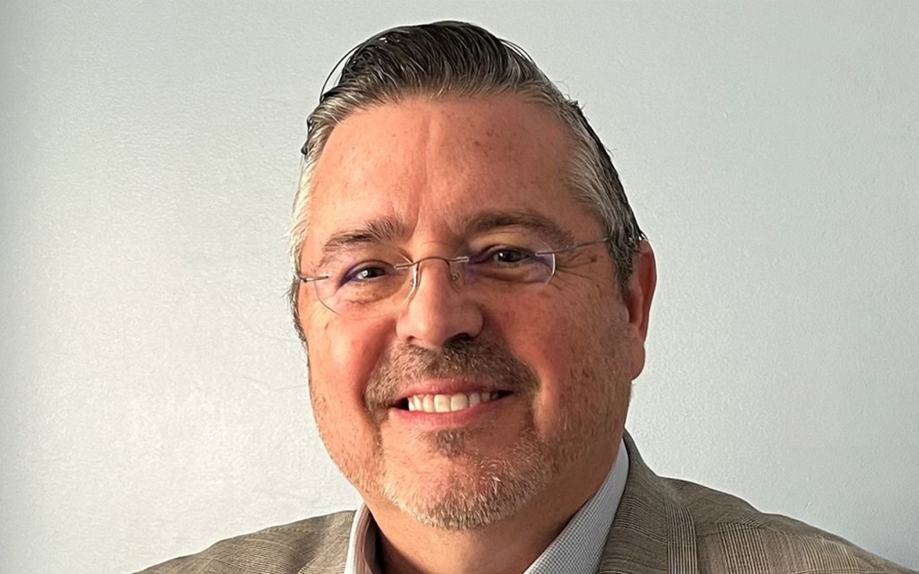 A man with glasses and a beard.